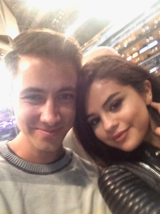 Selena with a fan on bascketball game