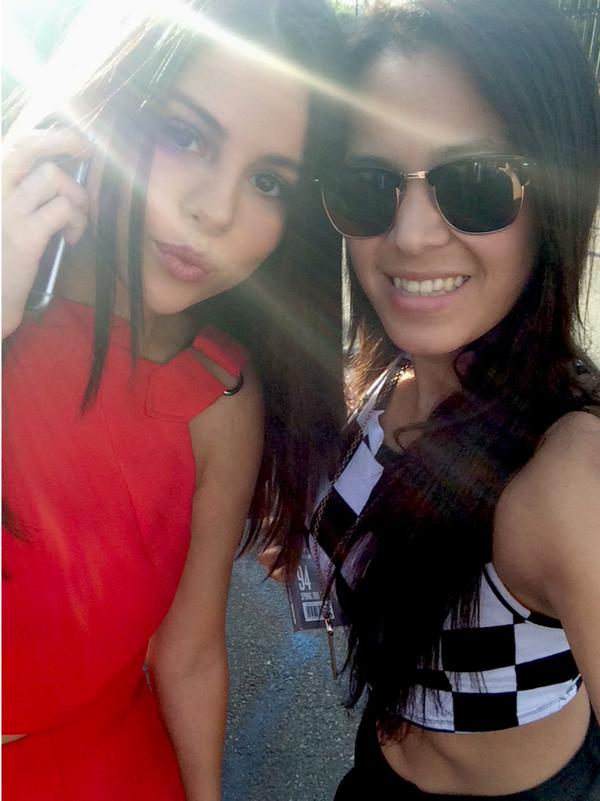 Selena with a fan near 97.1 AMP Radio studio