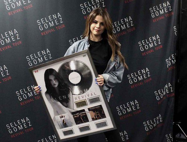 Selena holding Canadian Gold certificate