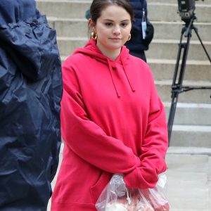 8 December: Selena rocking pink hoodie with long hair on set of Only Murders In The Building