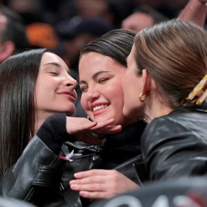 30 January: Selena’s friends give her kisses when Barclays Center’s camera notices them in the crowd at the basketball game