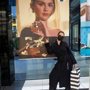 13 August: Selena poses in front of Rare Beauty promo poster